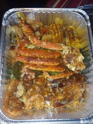 1/2lb shrimp, 1/2 lb tilapia with crab leg cluster, house and Cajun seasoning... extra seasoning.