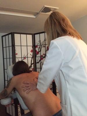 A client receives a half hour neck and back massage.