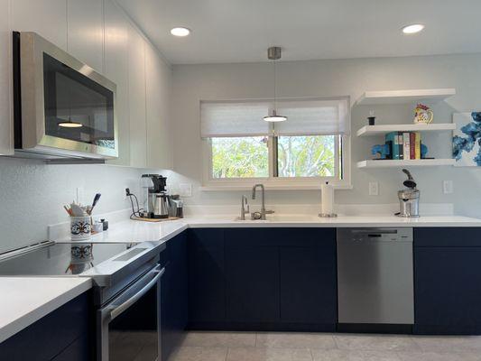 Modern Kitchen Complete Remodel. Beautiful custom cabinets finished with cool white uppers and navy lowers.