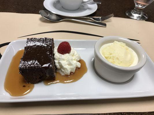 Chocolate fudge brownie with butterscotch and whipped cream, homemade vanilla ice cream