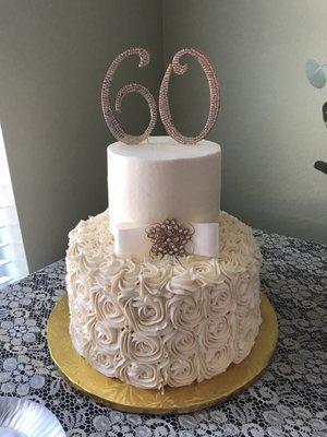 Bottom layer was lemon with raspberry cream, top layer was vanilla with Bavarian cream.  Buttercream frosting in an ivory color.