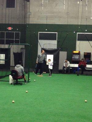 Tom Shelley instructing a player during a lesson.