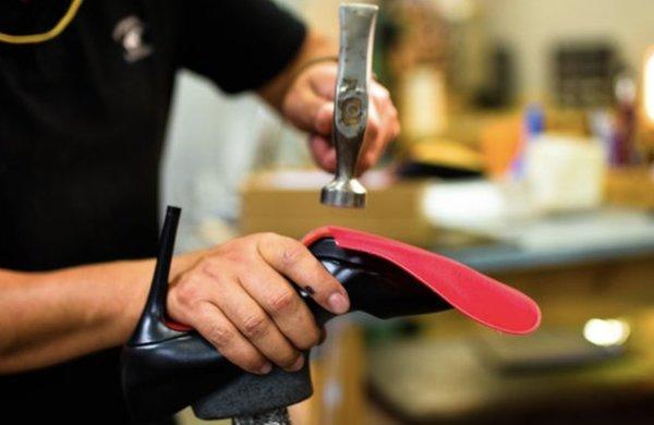 Applying the red sole protector to Christian Louboutin heels.