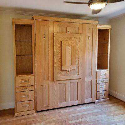 Wall bed with integrated desk, closed.