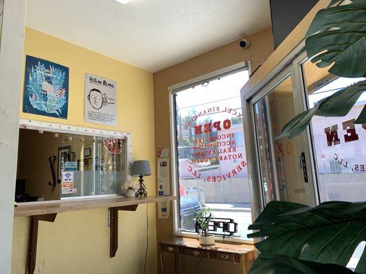 Photo of desk window inside the main entrance from a seat in the small lobby area.