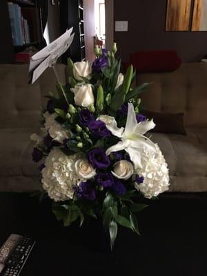 White hydrangeas, roses, and Stargazer lilly, plus fragrant purple lisianthus and statice to celebrate the Northwestern grad!