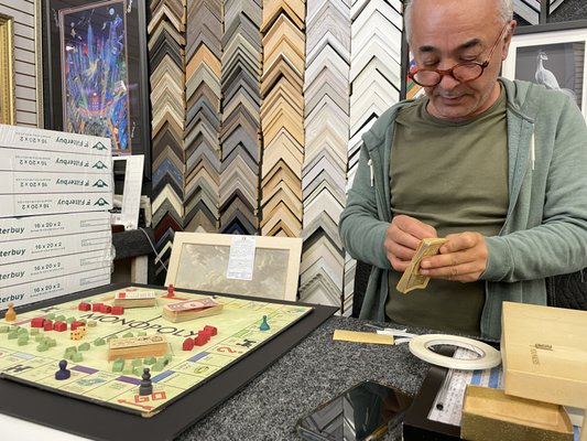 Jimmy preparing the Monopoly Game to be framed.