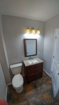 Complete overhaul of bathroom. New flooring, shower, vanity, lighting, and toilet.