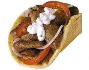 Gyro On pita bread with tomatoes, onions topped with Tzatziki sauce