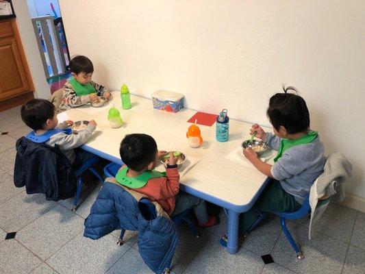 Lunch time, older kids learn to feed themselves