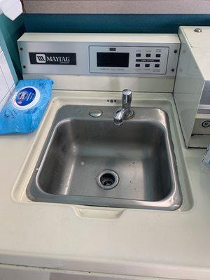 The courtesy sink is mounted in a washing machine! How awesome is that?!