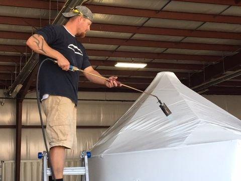 Shrink-wrapping a boat.