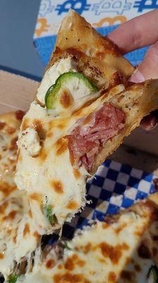 POPPER PIZZA with spicy garlic oil, pickled jalapeños, prosciutto, cream cheese, and mozzarella.