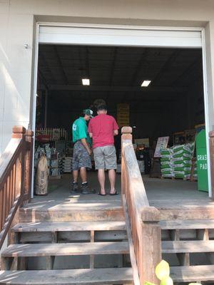 Dad and worker talking about the best route to go for our yard grubs.