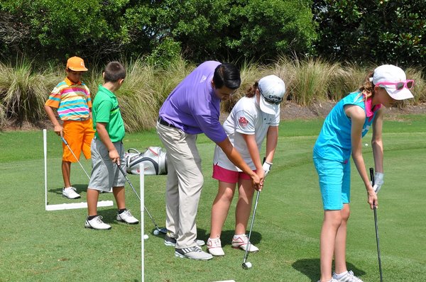 A few youngsters learning the game of golf during a Junior Golf Camp.