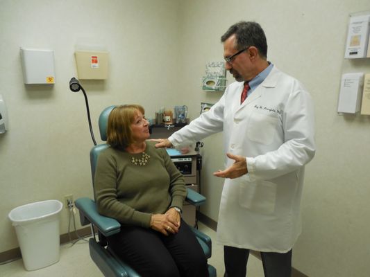 Dr. Jay Klarsfeld, Otolaryngologist,  discussing a diagnosis with a patient.