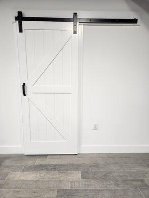 Enhance any opening with a barn door with a barn door track.  As seen here in our renovated showroom.