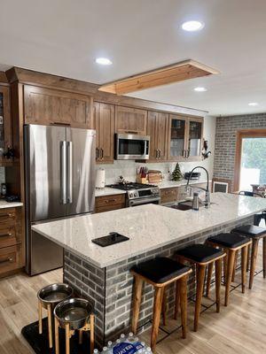 Full kitchen remodel with accent brick, quartz countertops and backsplash.   New Luxury vinyl flooring and beautiful Masterpiece cabinets.