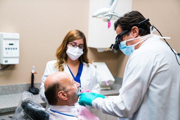 Dr. Leonard Gordon examines a dental patient.