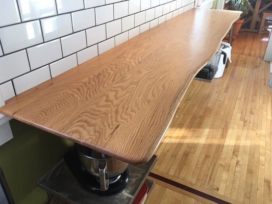 Chris = Real Estate Agent & Woodworker. Here's a natural edge white oak countertop with a custom stainless shelving base.