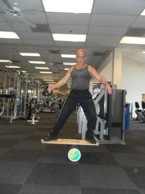 Balancing on an Indo Board doing Kettle Ball Swing Ups 1