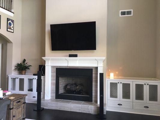 Built in cabinets on either side of the fireplace with metal inserts in the doors