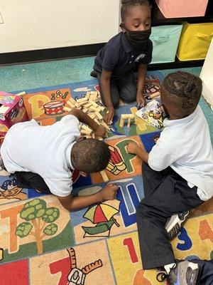 Kids engaged in hands on learning , kinder class.