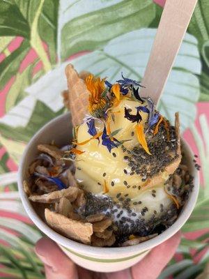 Mango Creamsicle! Mango Sorbet topped with housemade organic waffle pieces, organic chia seeds, caramel sauce and edible flower sprinkles.