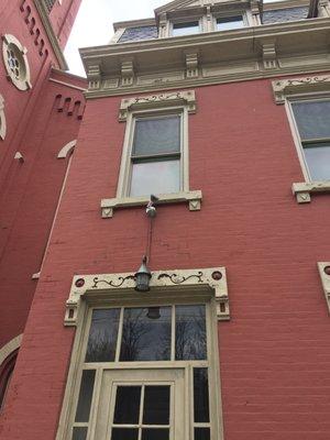 interesting wood cutout design in windows of the building outside