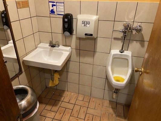 The men's room has no toilet. Just a urinal and the sink.