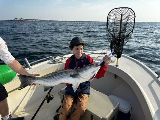 Young, proud fisherman with his prized catch.  Thanks to Capt. Patrick this young man has a love of the Sea.