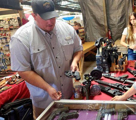 Brian Carter showing my confused Wife the gun.  She is under numerous medications for her severe concussion. I told him to STOP!.