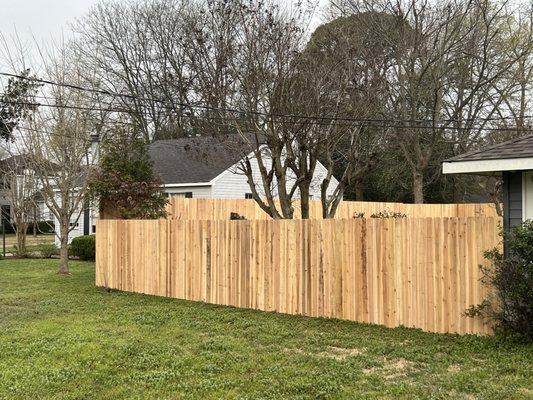 Beautiful 8 ft tall cedar fence tied into a 6 ft tall cedar fence with an extremely happy customer. For a free quote call today 318-771-2137