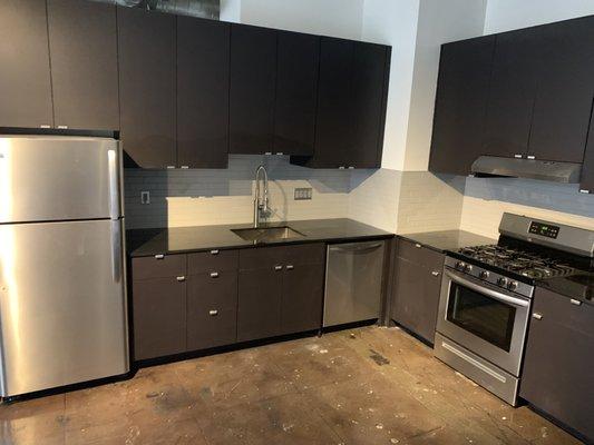 Brand-new appliances and polished concrete flooring, with recessed lighting.