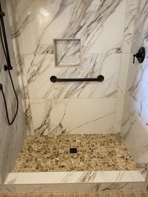 4'x2' porcelain tile shower with pebble shower floor