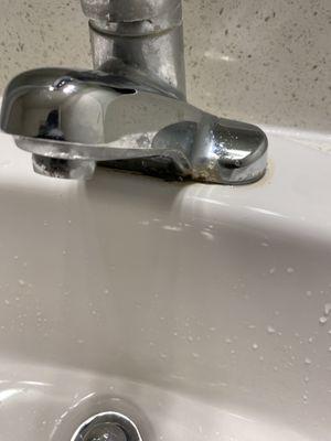 It leaks from under and near the base of the faucet when the water runs.