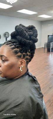 Barrel twist updo on long locs.