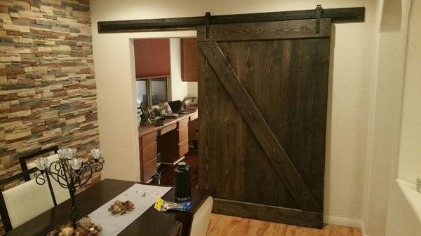 Hand built and stained barn door and rail assembly