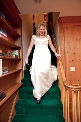 Photo by Brianne Bradbury Photography - Shot of the bride coming downstairs after getting dressed in upstairs bedroom.