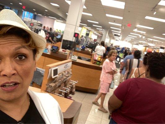 A patient line of locals grabbing some last minute deals on duty free weekend. Line goes as long the either way as well.