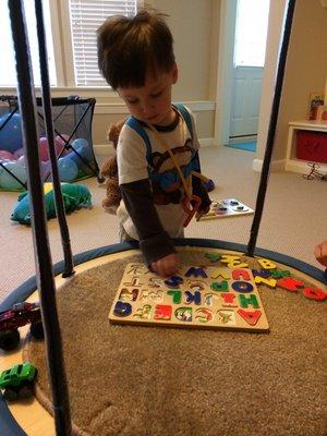 Weighted backpack with a one hook suspension swing completing an ABC puzzle.