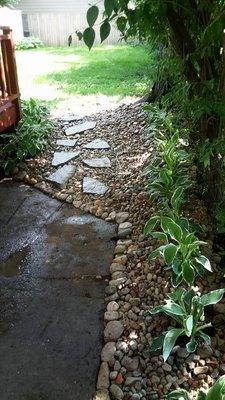 Newly landscaped area where there had only been mud.Finished with hosta, river rock, and a new stepping stone path.