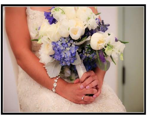 Blue and white bridal bouquet of garden roses, blue hydrangeas, peonies, sweet peas, veronica and trimmed with sliver dusty miller.