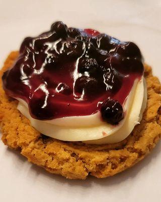 Deluxe cookie topped with homemade cream cheese and blueberries