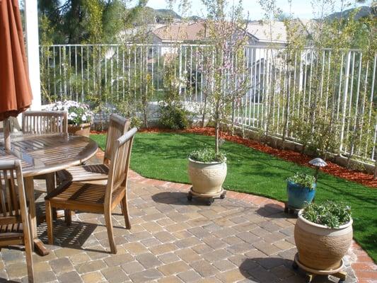 Beautiful backyard makeover with pavers, and artificial lawn