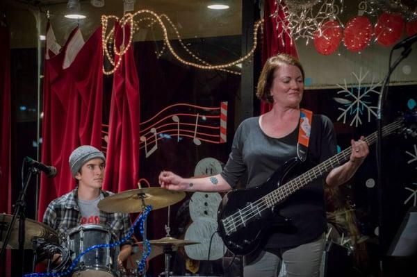 Adult bass student playing a Pixies' tune at our December First Fridays recital (accompanied by her son on drums)!