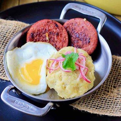 Desayuno Dominicano
 Boiled Plantains Laced with Fried Eggs / Salami / Cheese