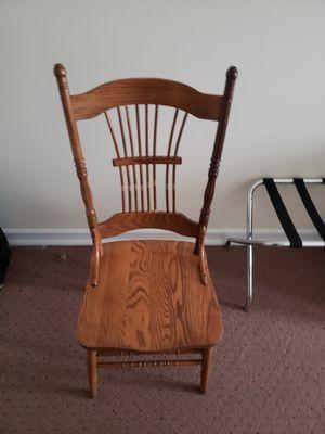 Worn, damaged furniture, chair missing a spindle.