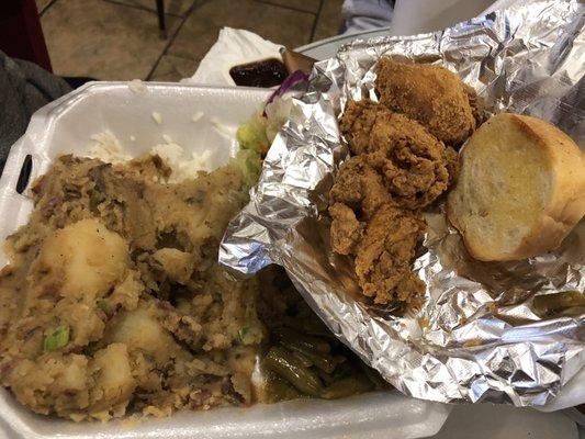 Smothered potatoes, chicken wings, green beans & salad