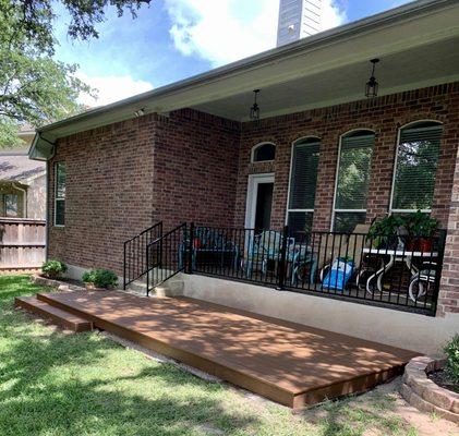 A low to the ground deck. Although not visible, this deck has a proper lining and a pebble rock foundation to prevent weeds thru deck.